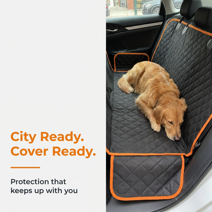 Golden retriever resting on orange-edge dog car seat cover in the city