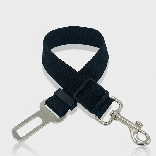 Black nylon dog car seat belt tether with a metal seat belt buckle clip, adjustable slider and swivel snap hook, shown on a white background.