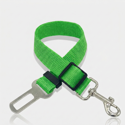 Green nylon dog car seat belt tether with a metal seat belt buckle clip, adjustable slider and swivel snap hook on a white background.
