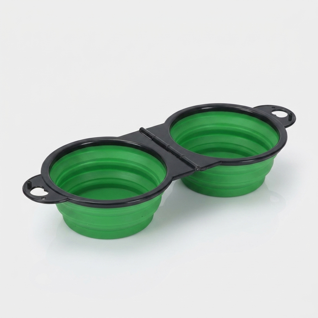 A green foldable dual bowl feeder sits open and ready for food and water.