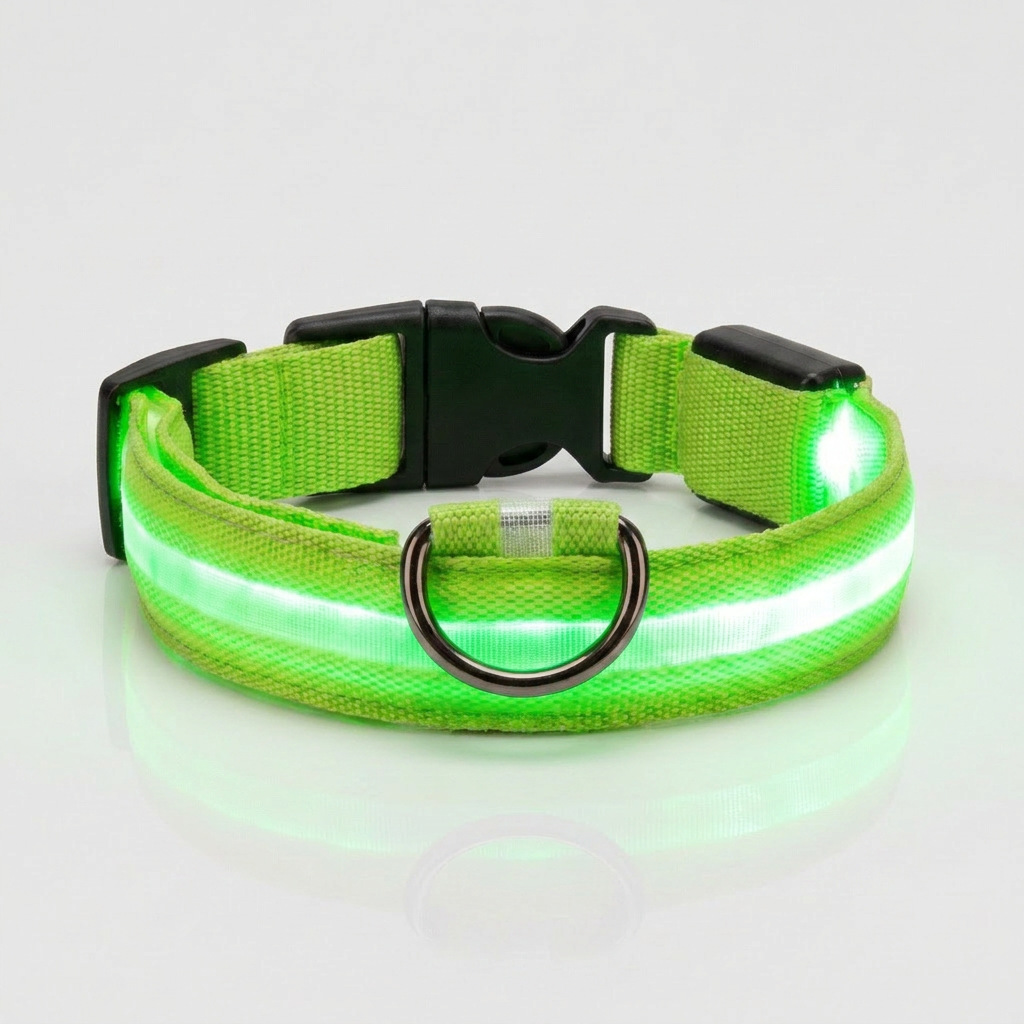 Green light-up nylon dog collar glowing with an illuminated LED strip, shown against a plain grey studio background with a metal D-ring and quick-release buckle.