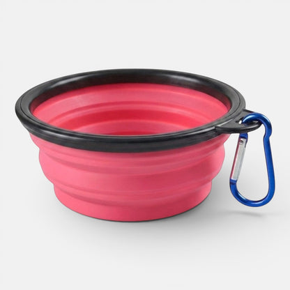 A pink collapsible silicone travel bowl for dogs shown open on a plain background.