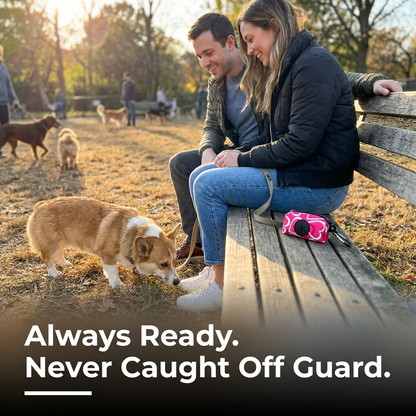 Couple with their dogs outdoors, always ready for cleanup