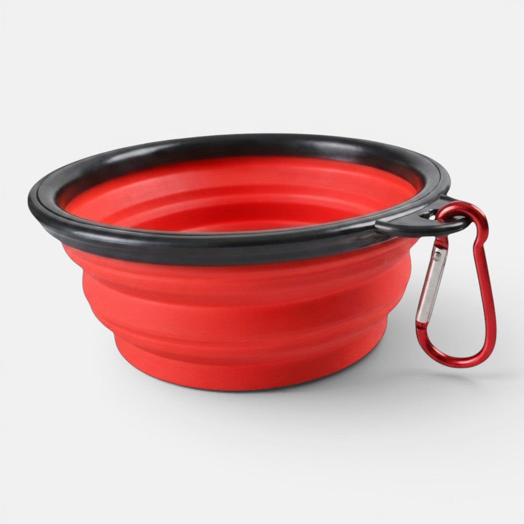 A red collapsible silicone travel bowl for dogs shown open on a plain background.