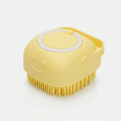 Yellow silicone dog bath brush with a built-in shampoo dispenser cap and smiley face, shown on a white background.