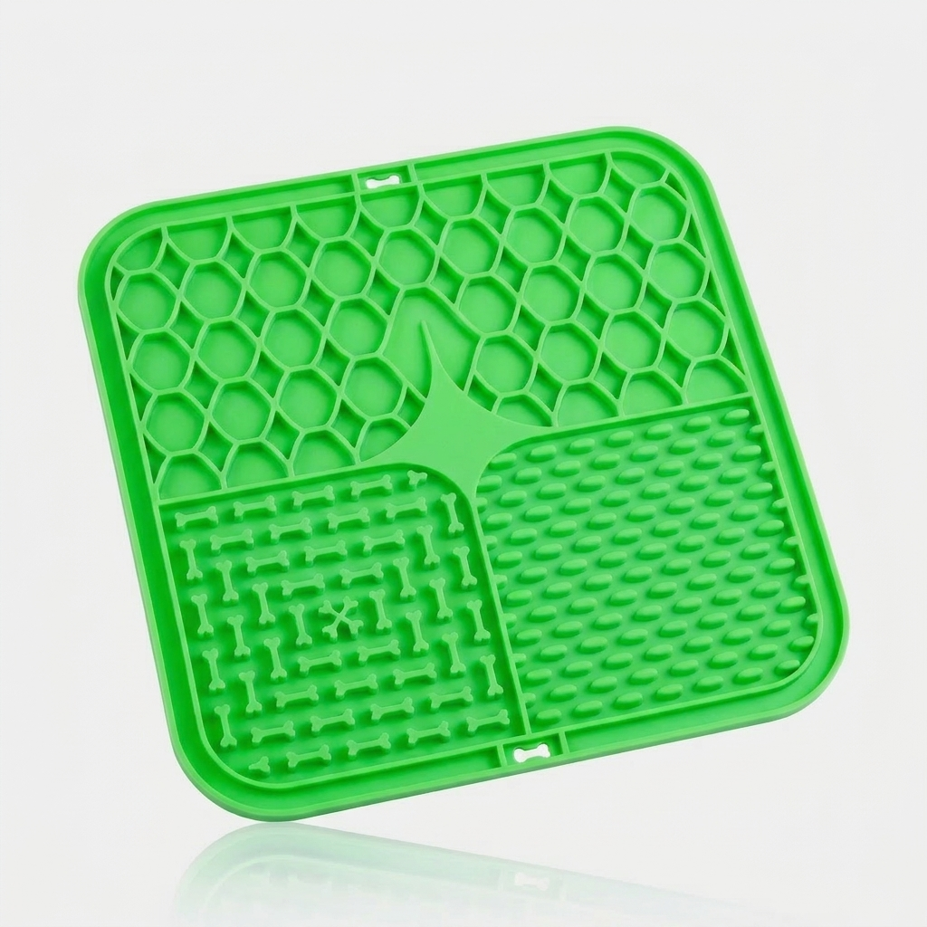 Green silicone lick mat for dogs with three textured feeding zones, shown at an angle on a white background.