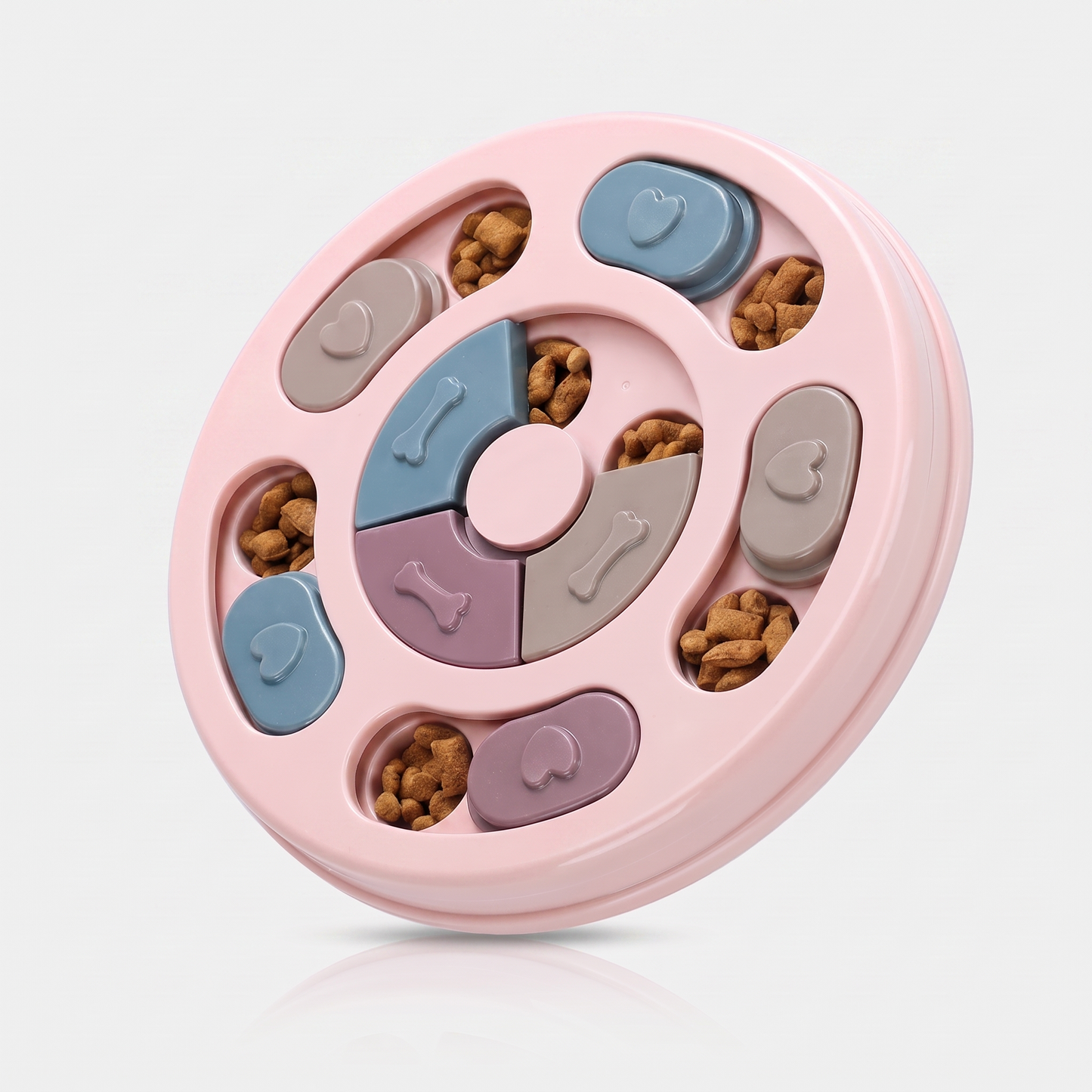 Pink interactive slow feeder puzzle bowl for dogs with pastel sliding covers and kibble in the wells