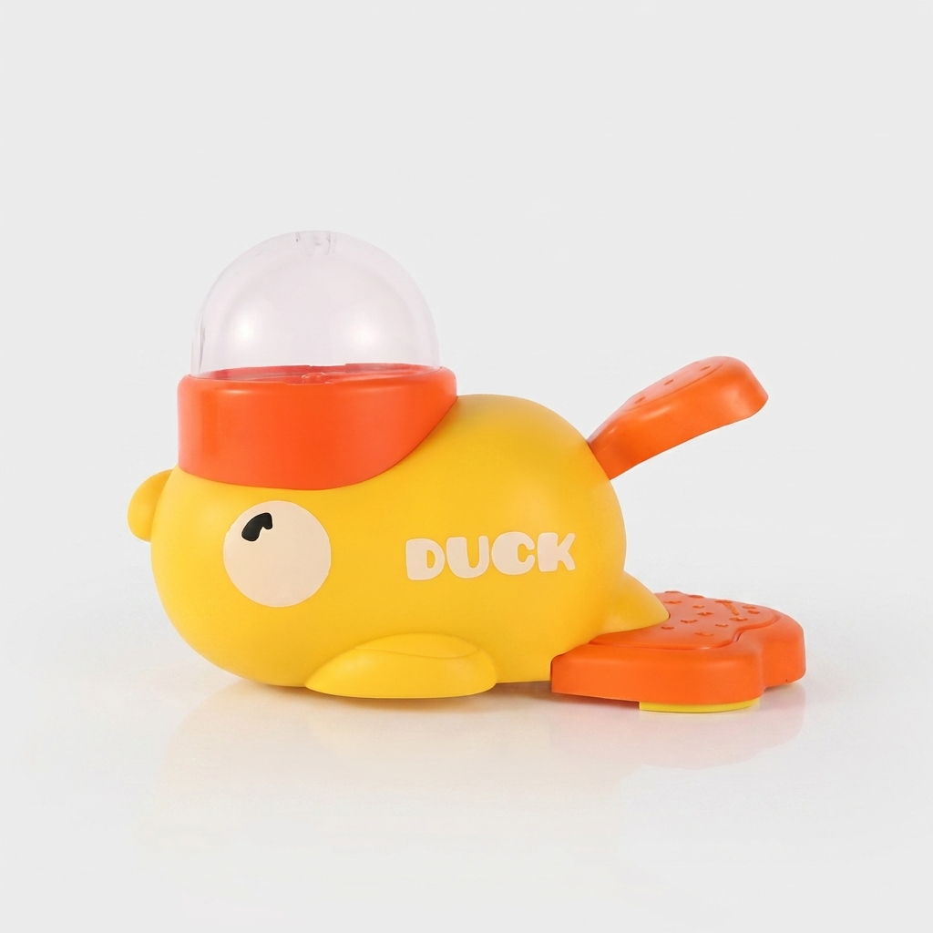 Yellow duck-shaped treat dispenser slow feeder toy with orange feet and a clear dome top, shown from the side on a plain white background.
